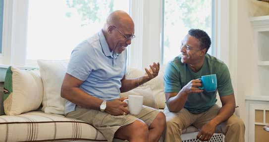 two retired men discussing retirement coverage